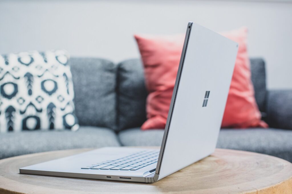 Have You Tried Out Microsoft Designer Yet? (Get The Scoop Here) macbook pro on white couch